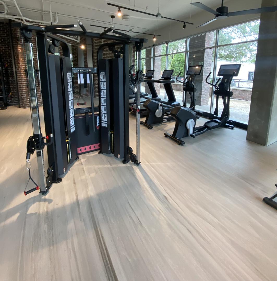 A variety of gym equipment installed all overtop of Moxie flooring